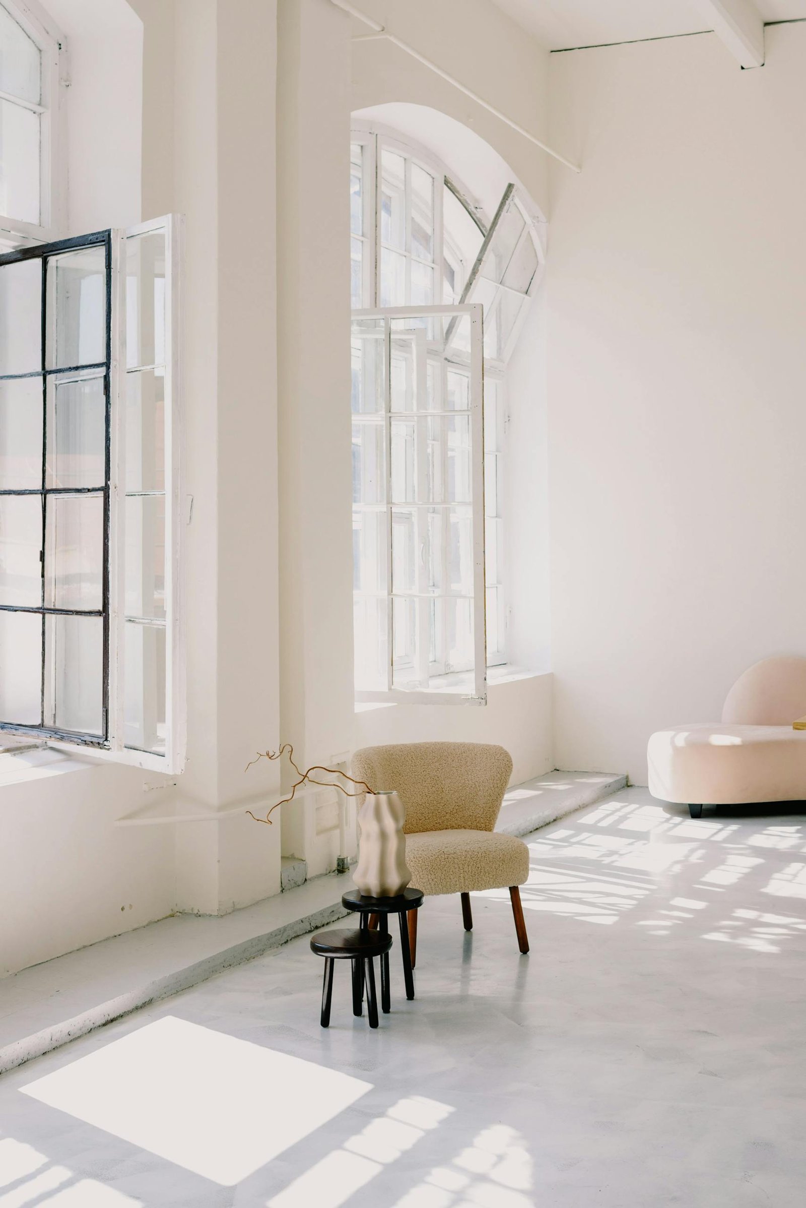 Minimalist interior design featuring large windows, soft lighting, and contemporary furniture.